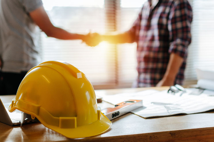 Employee shaking hands with his boss.