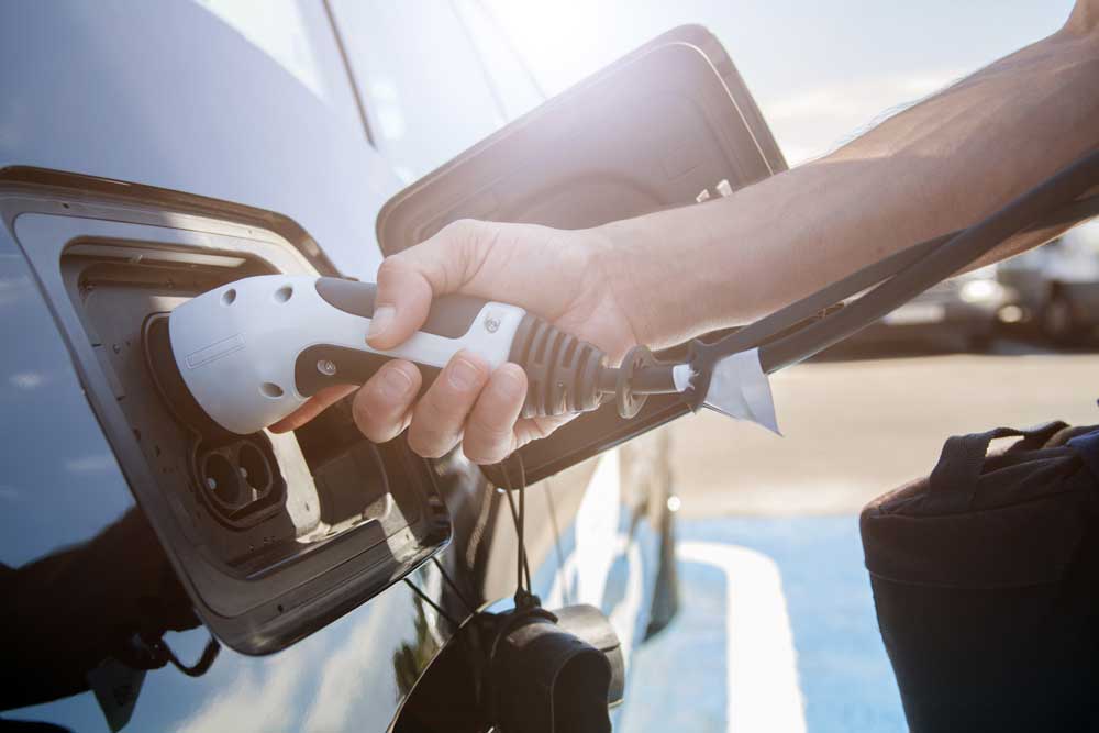 An electric vehicle being charged with charge port connection.