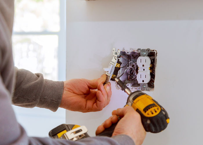 Electrician installing light switch.